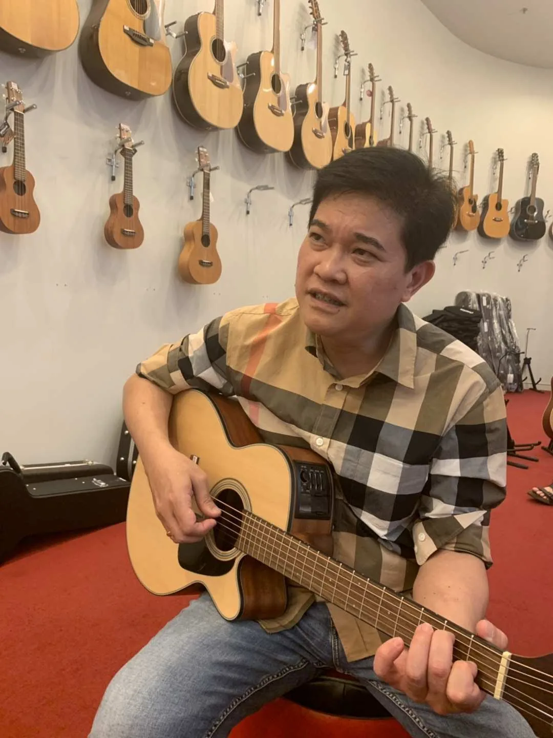 Playing acoustic guitar in a music store