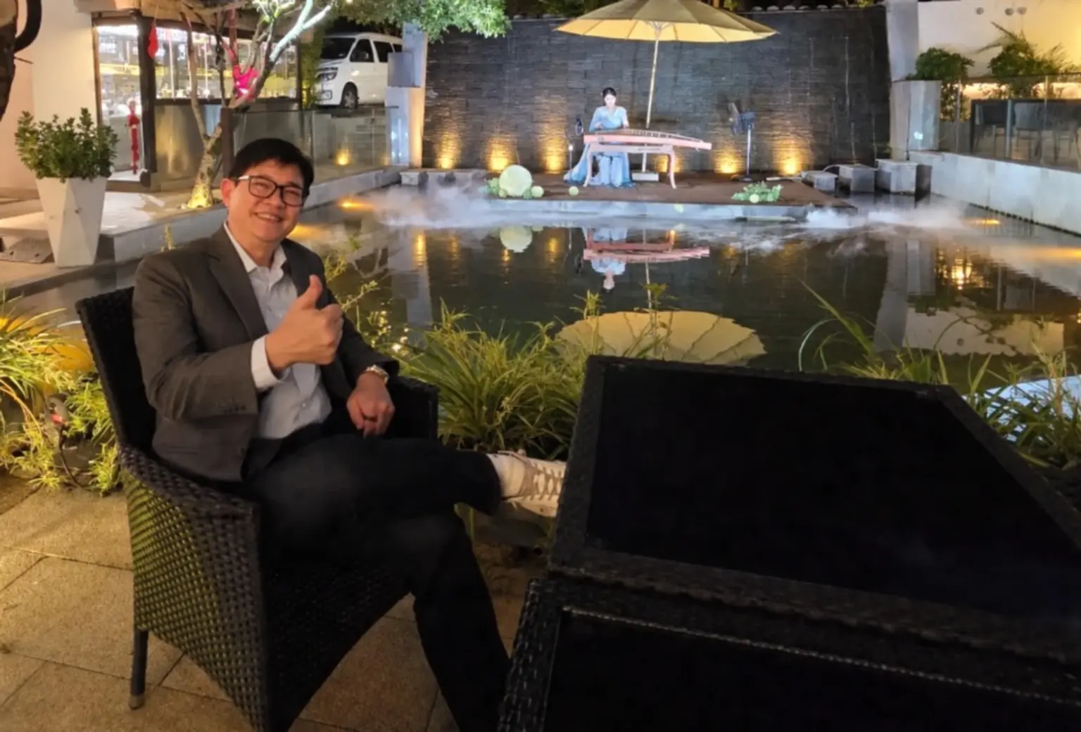 An intimate evening performance beside a pool